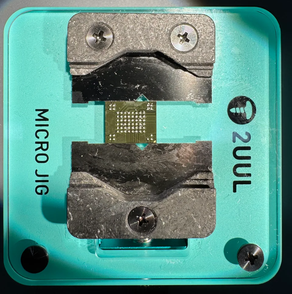 The Motorola APX900 BGA63 flash-memory chip secured in a micro jig.
