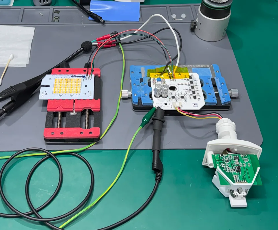 The outdoor smart light's LED board and control electronics connected for bench testing, with the LEDs off.